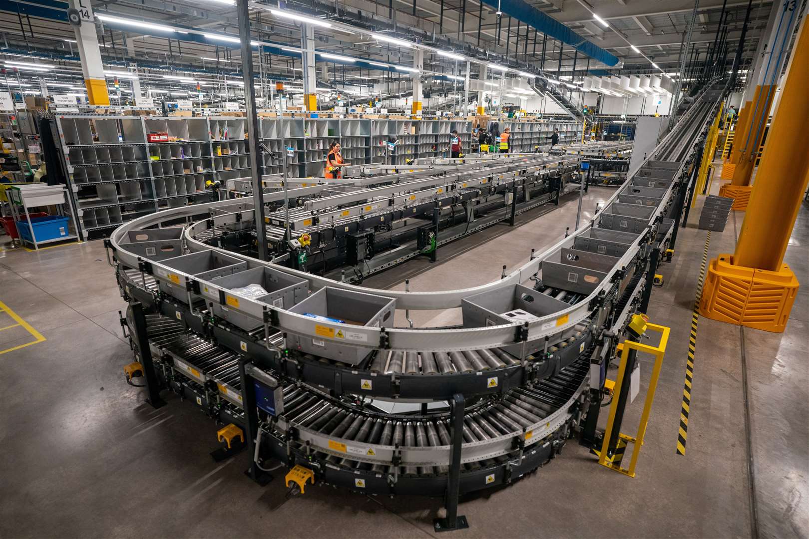 Parcels move inside boxes on conveyor belts (Ben Birchall/PA)