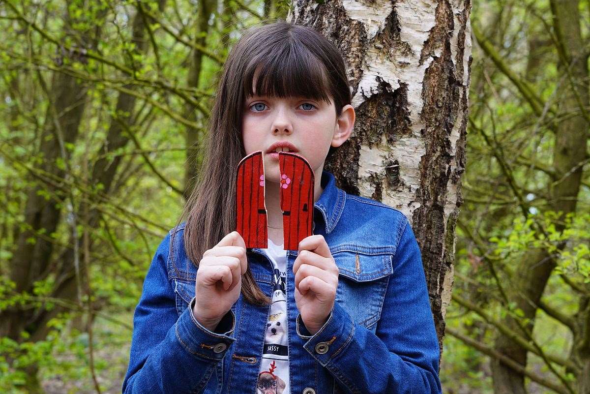 Hannah Haynes, 9, with one of the vandalised fairy doors at Newington near Sittingbourne. Picture: Phil Haynes