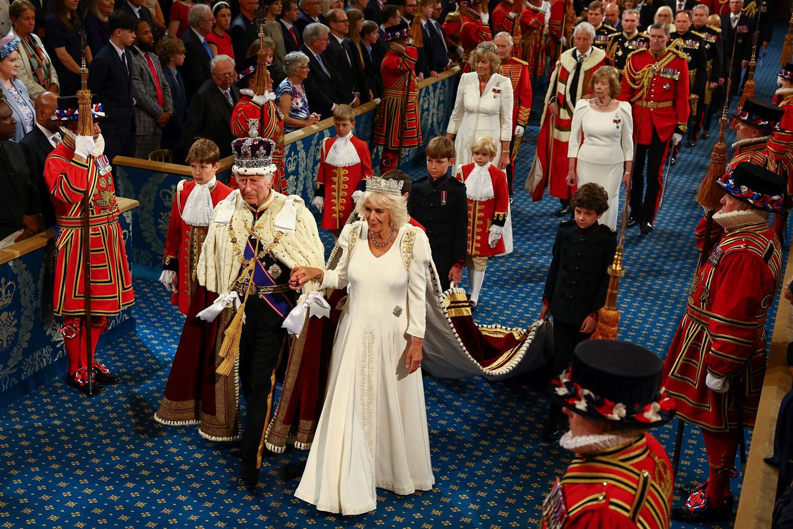 The King, wearing the Imperial State Crown and the Robe of State, and Queen, wearing the George IV State Diadem, leave after the State Opening of Parliament (Hannah McKay/PA)