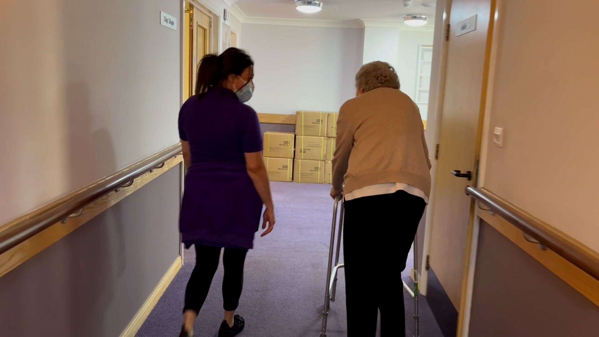 A resident speaking with a carer at Amherst Court