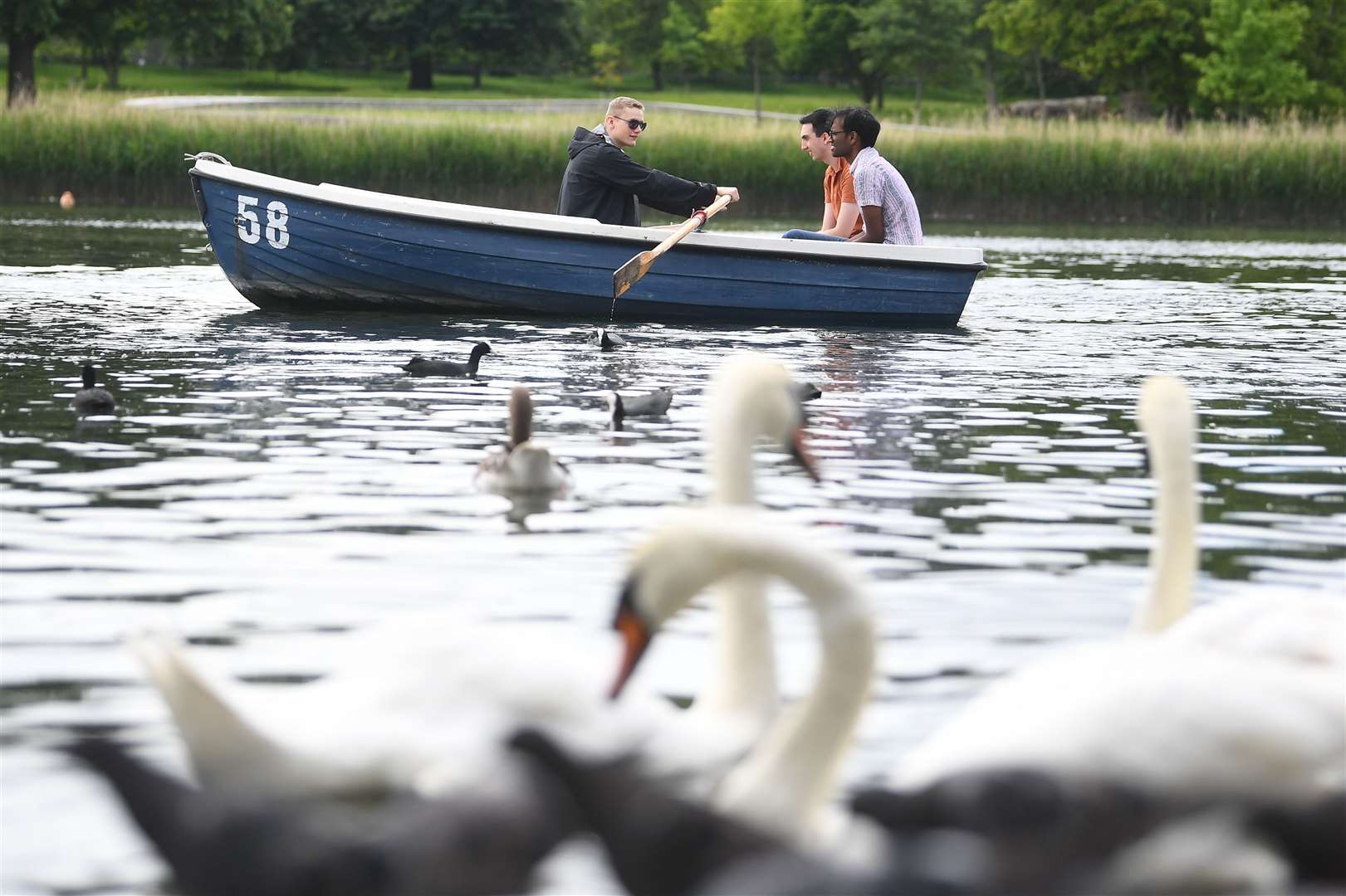 People in a boat on the Serpentine in Hyde Park (Victoria Jones/PA)