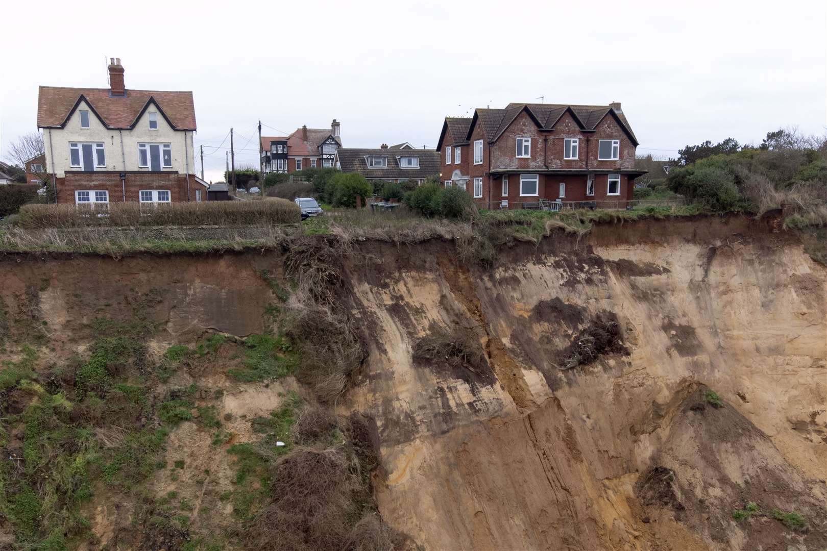 Houses sit close to the edge after a cliff collapse at Mundesley in north Norfolk (Joe Giddens/PA)