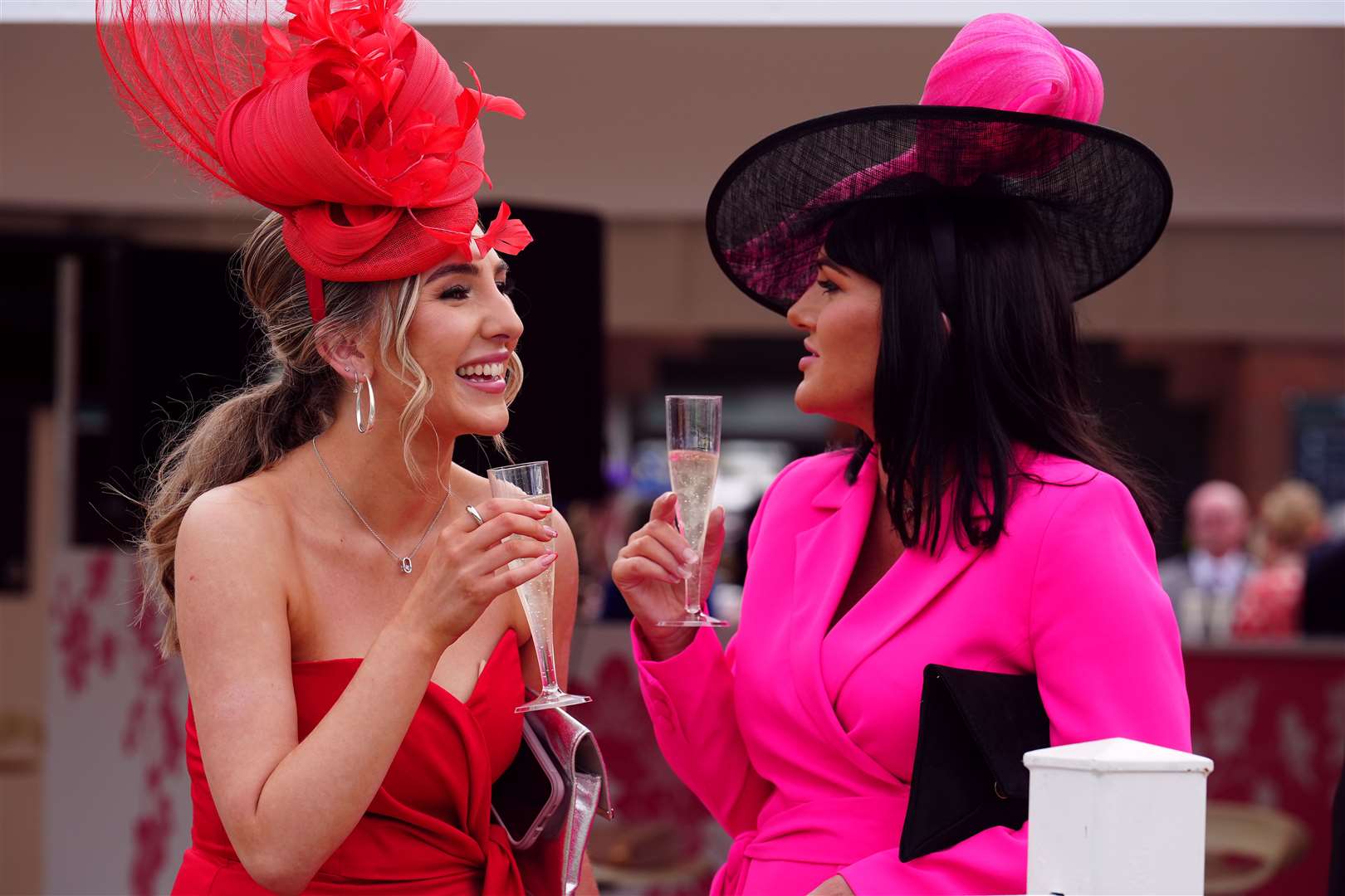 Two visitors enjoy a drink before the racing begins (Mike Egerton/PA)