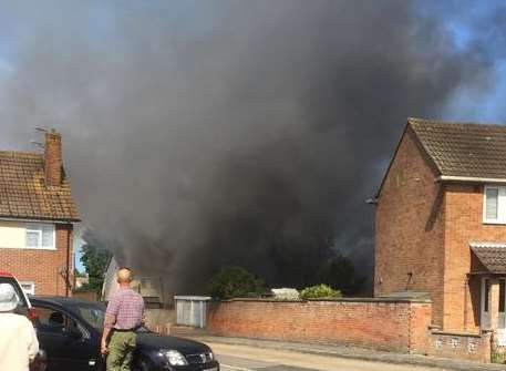 Thick black smoke billowing from the homes