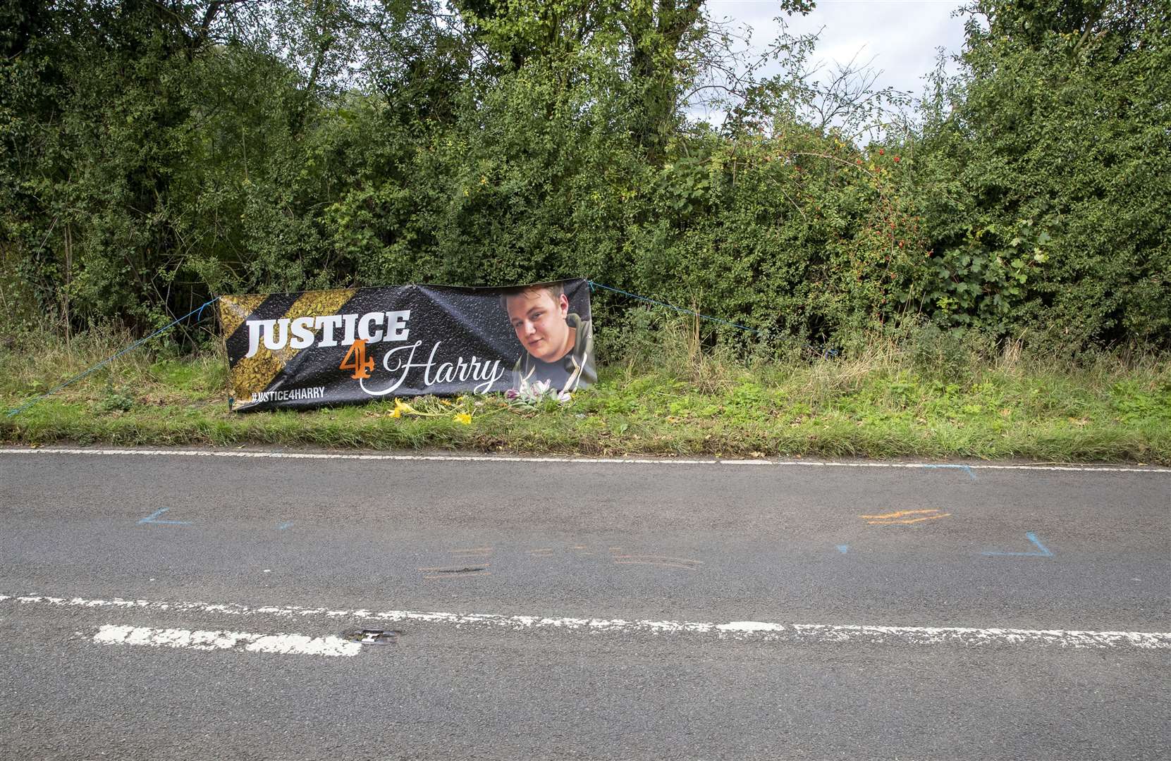 Floral tributes on the B4031 outside RAF Croughton, in Northamptonshire, where Harry Dunn, 19, died (Steve Parsons/PA)