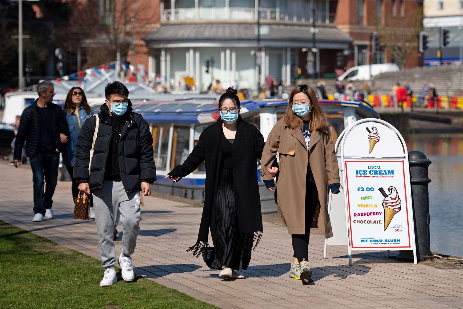 People wearing protective face masks walking in Stratford-upon-Avon in Warwickshire (Jacob King/PA)