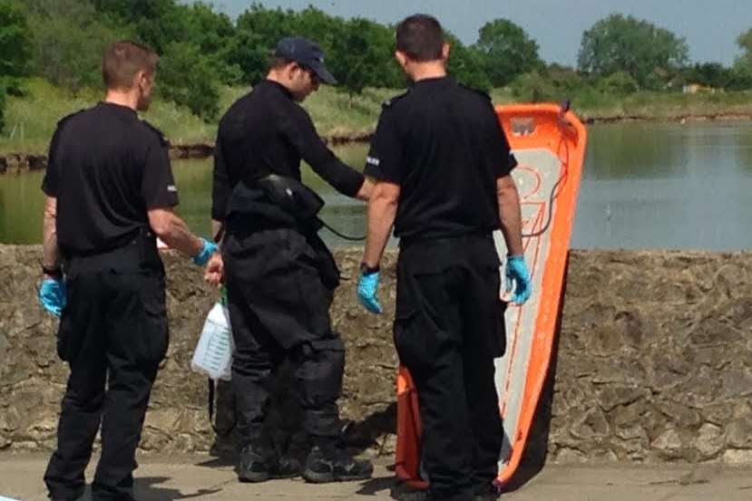 Officers at the canal after a body was found