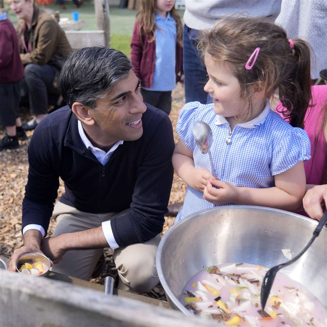 Mr Sunak accepted a cup of a fruity concoction mixed up by the young pupils (Danny Lawson/PA)