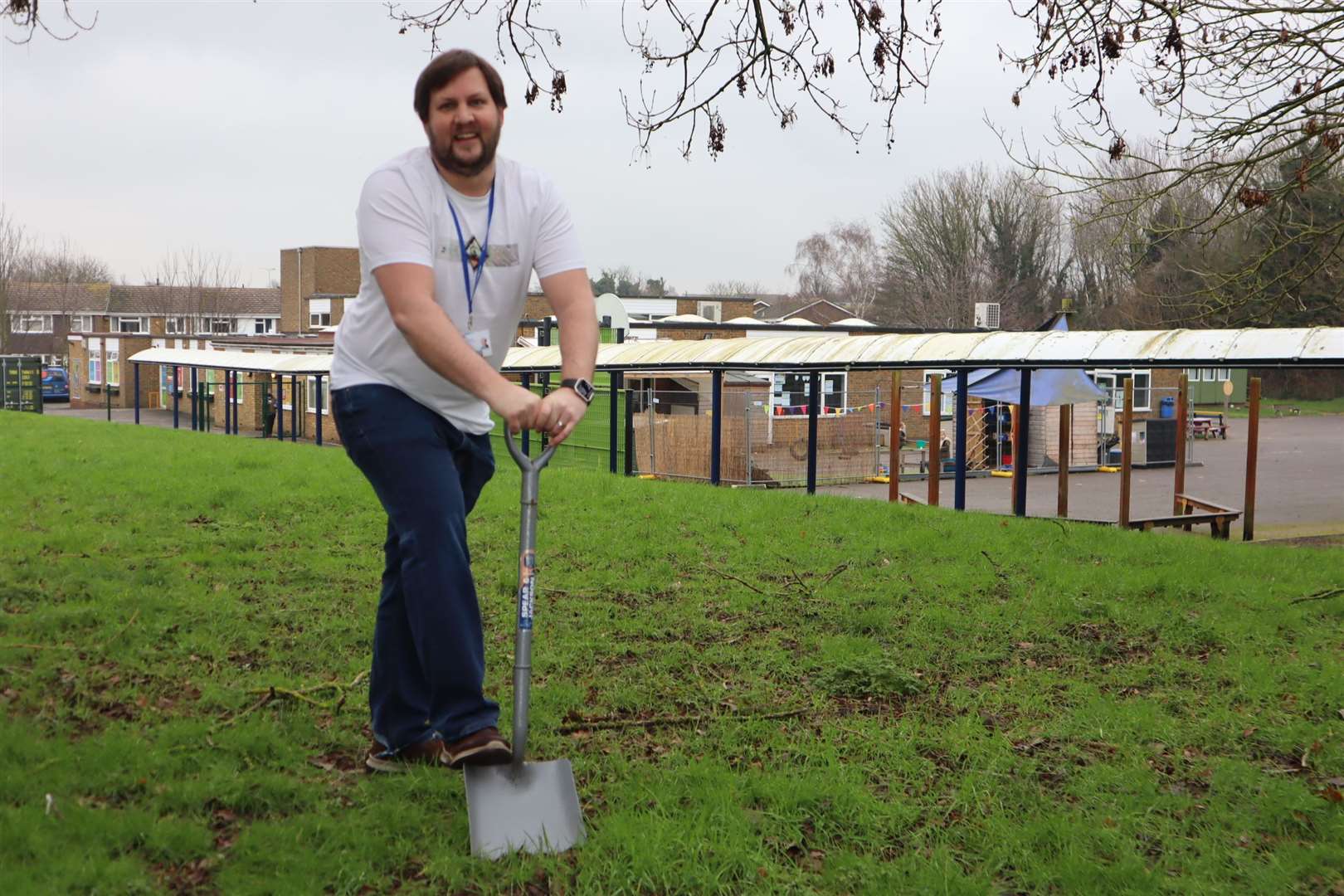 Sunny Bank head of school Darren Waters digging a hole for a time capsule at Murston