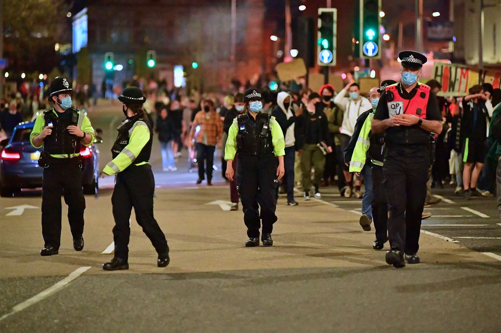 Police officers watch on as people take part in a ‘Kill The Bill’ protest in Bristol against The Police, Crime, Sentencing and Courts Bill (Ben Birchall/PA)