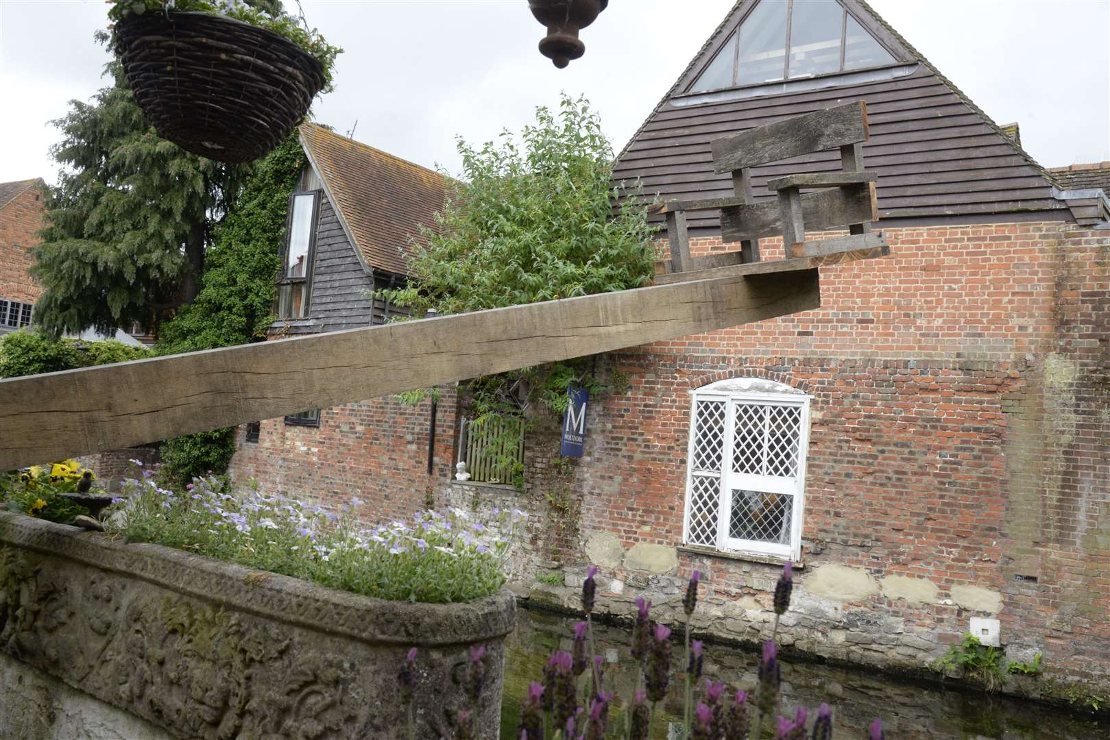 A ducking stool stick hangs over the River Stour in Canterbury