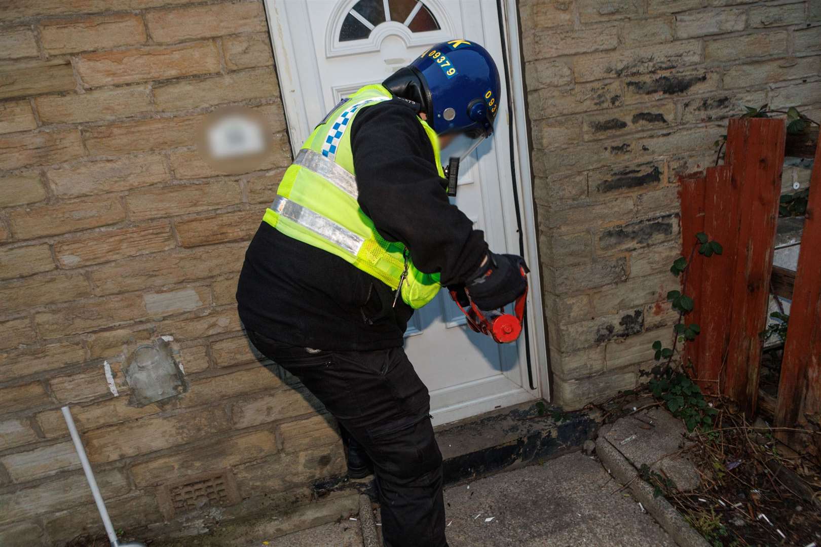 Police executing a warrant in Bradford (GMP)