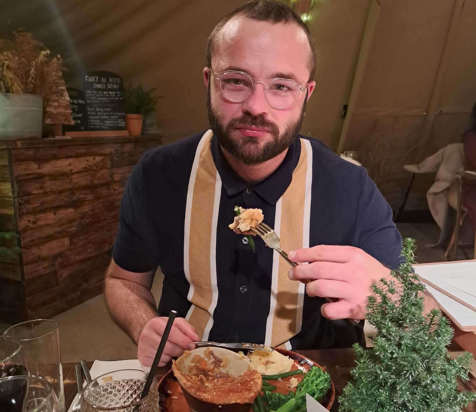 One unhappy looking yet internally completely content pie-eating reviewer