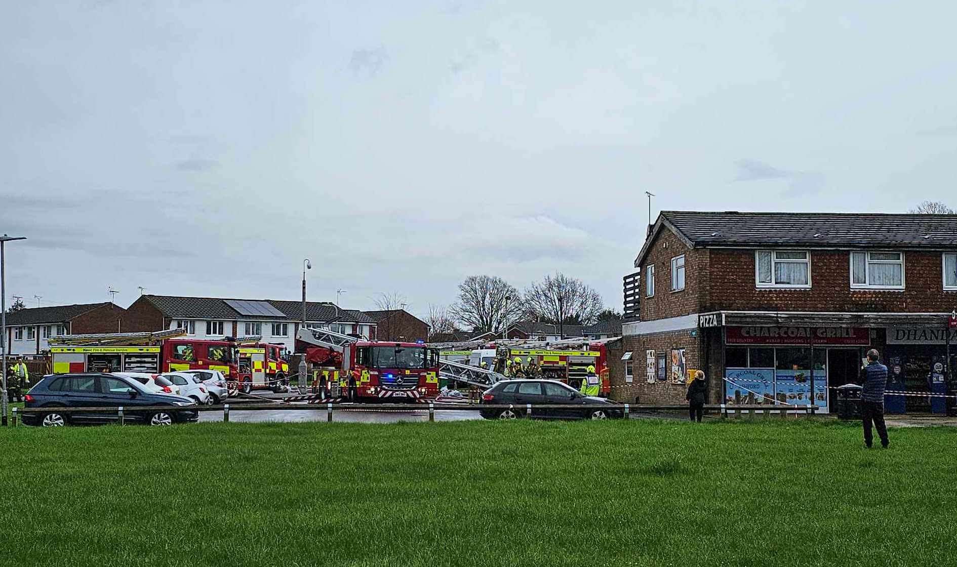 Fire engines can be seen in Bockhanger Lane, Kennington, after a fire at Charcoal Grill