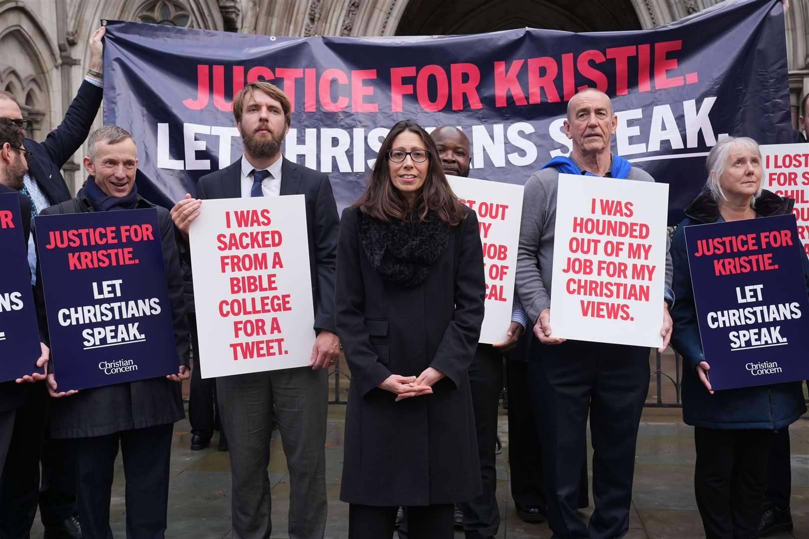 Christian school worker Kristie Higgs (centre) with supporters outside the Royal Courts Of Justice in London (Lucy North/PA)