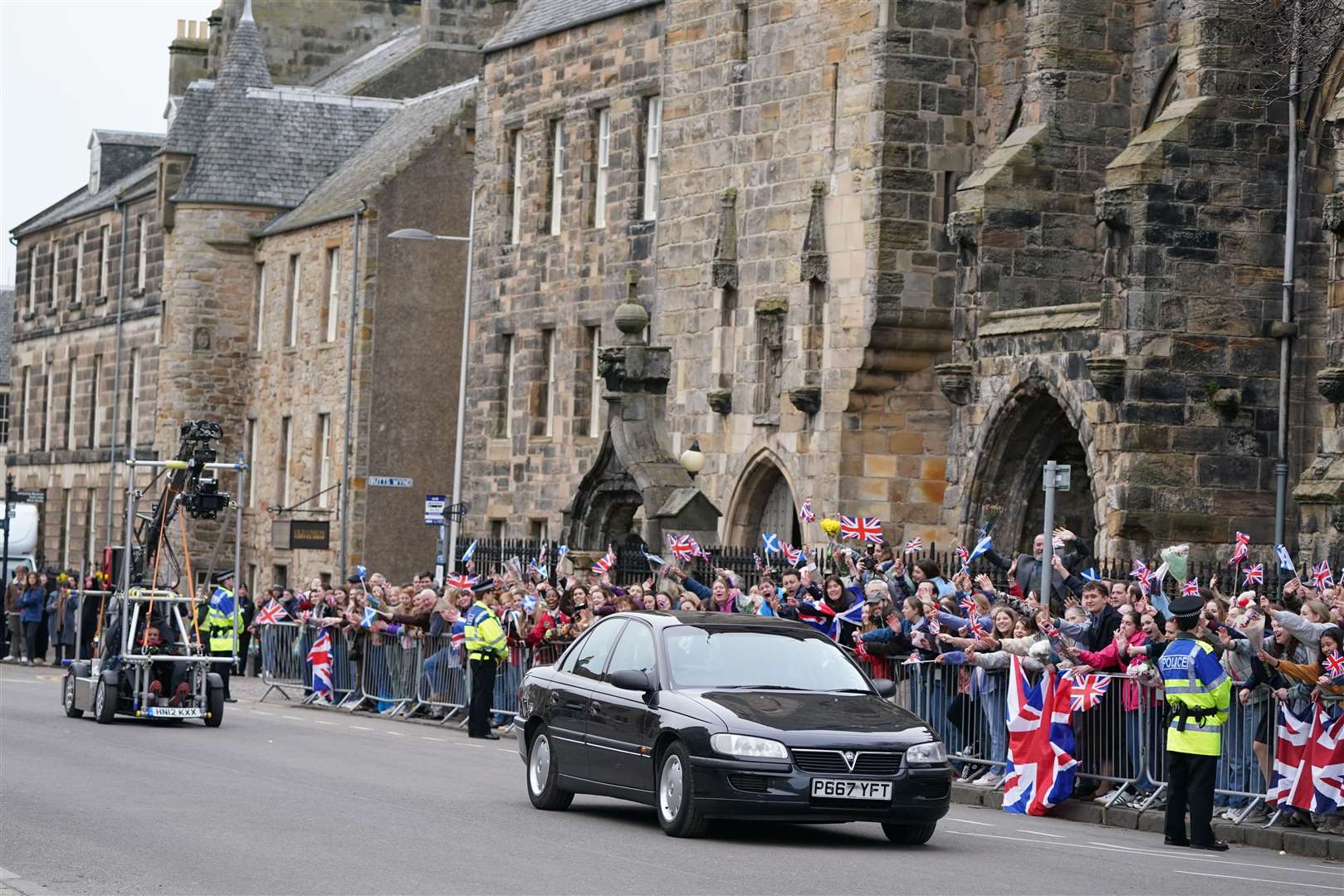 Ed McVey (inside car) plays the part of William as they film scenes for the next season of The Crown in St Andrews (Andrew Milligan/PA)