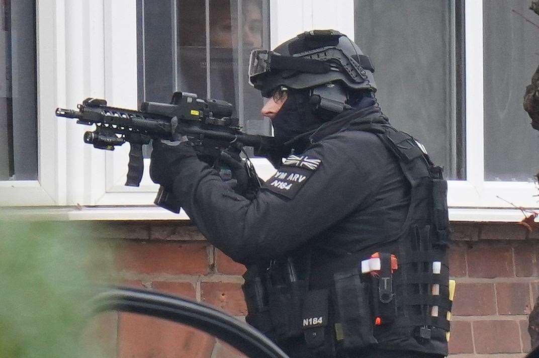 Armed police officers outside a property in Earlsdon Avenue North, Coventry (Jacob King/PA)