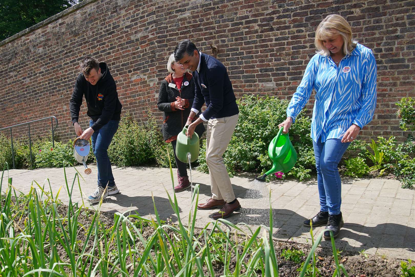 Prime Minister Rishi Sunak uses a watering can during a visit to a Big Help Out project in Bishop Auckland, County Durham, while on the General Election campaign trail (Peter Byrne/PA)