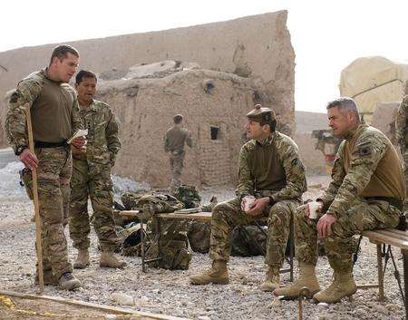 Major Shane Burton the Officer Commanding B Company briefs Brigadier Bob Bruce Commander of 4 Mechanized Brigade on the local area and how the Afghan Uniformed Police will maintain security once the base has closed.