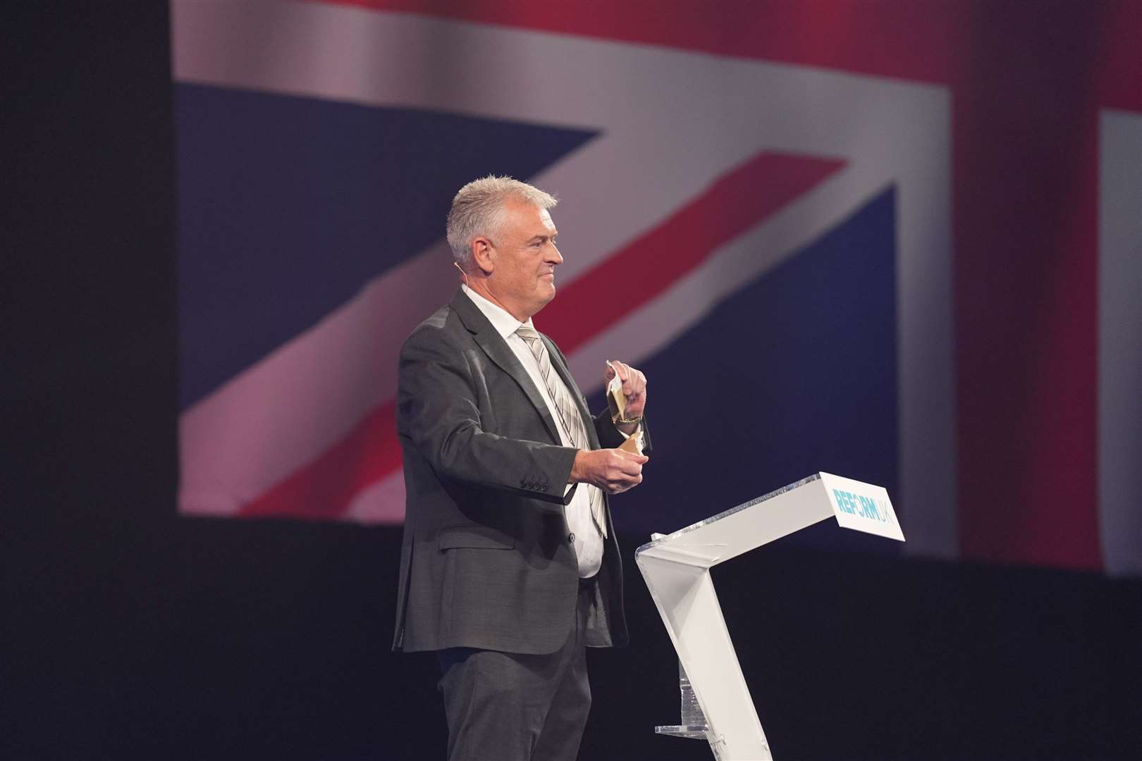 Reform UK MP Lee Anderson tears up his TV licence at the party’s annual conference at the National Exhibition Centre in Birmingham (Joe Giddens/PA)