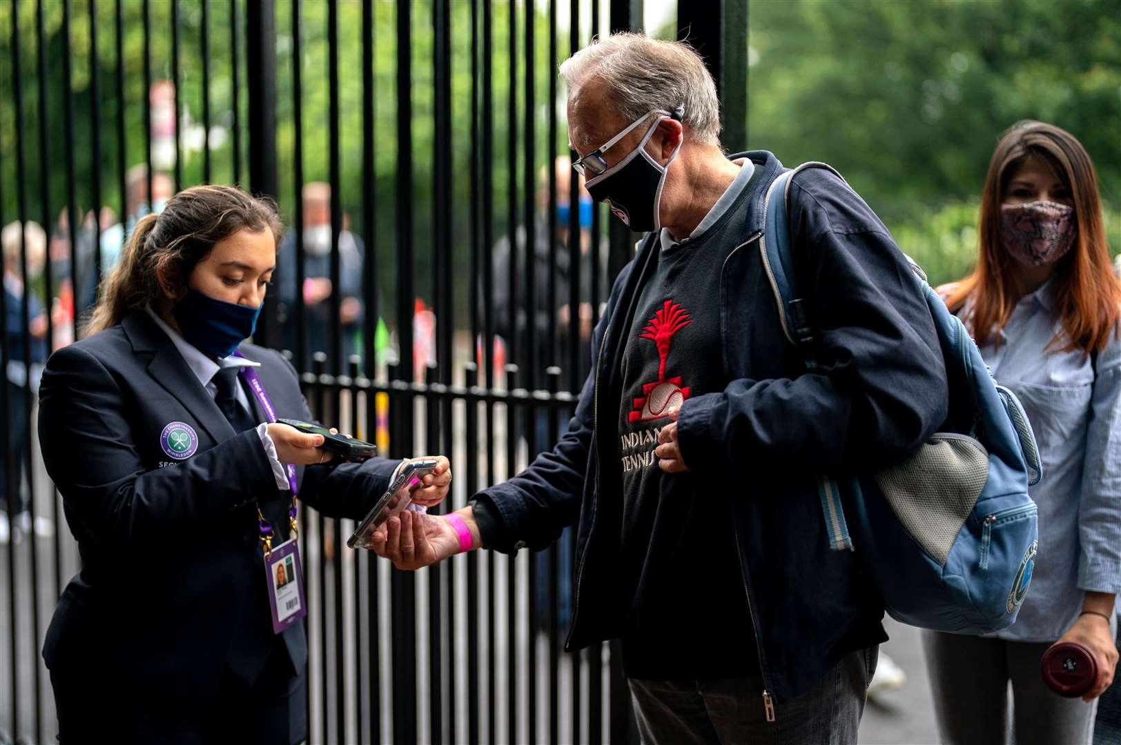 A spectator has a mobile ticket checked at the gate on day one of Wimbledon (AELTC Pool)