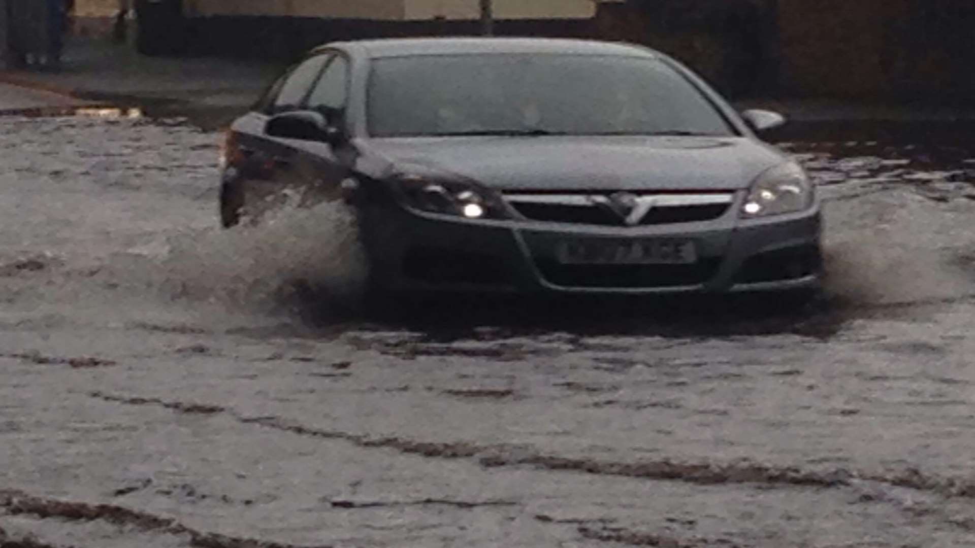 Like a river - New Romney High Street during flash flooding.