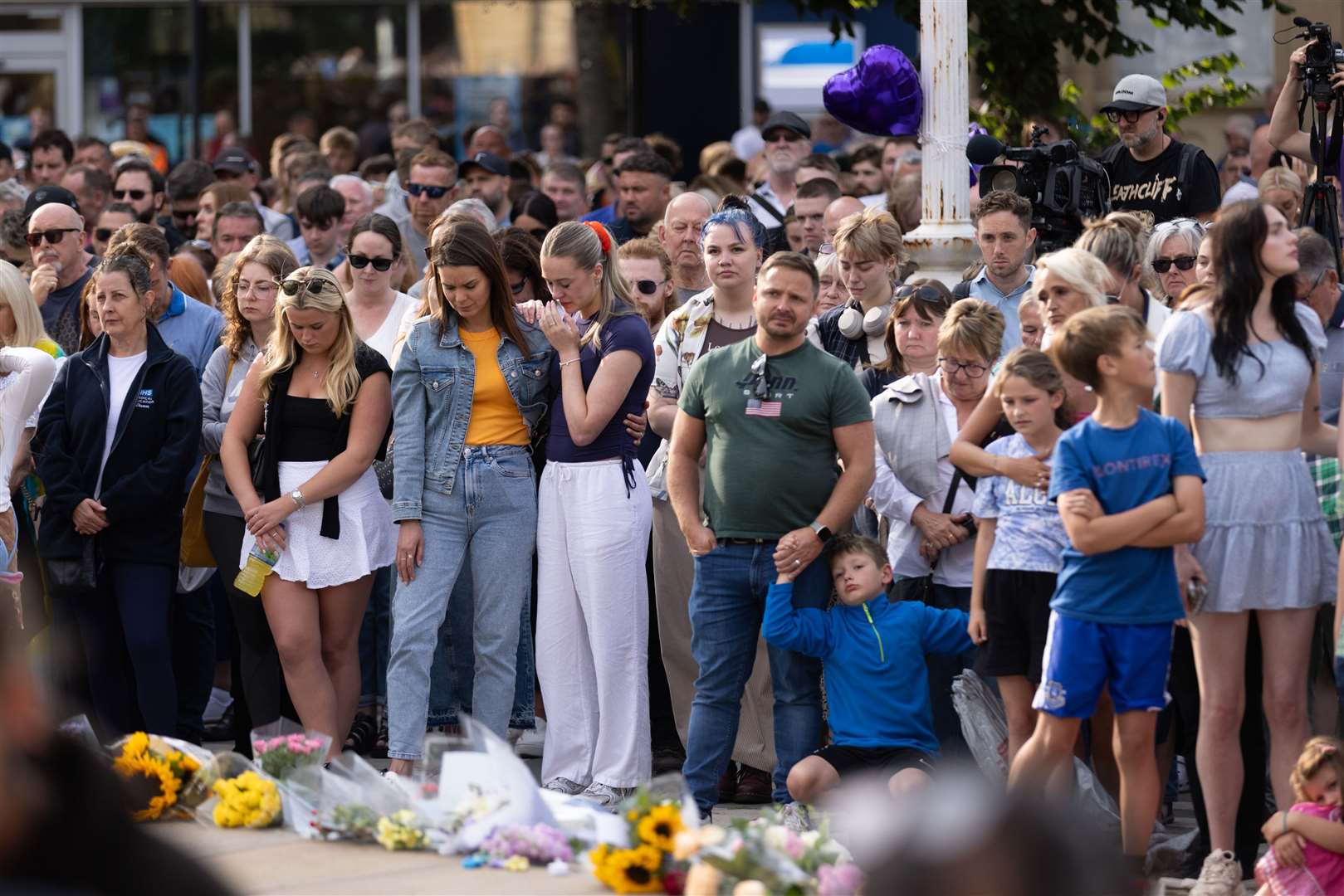 Members of the public take part in a vigil near to the scene of the attack in Hart Street, Southport (James Speakman/PA)