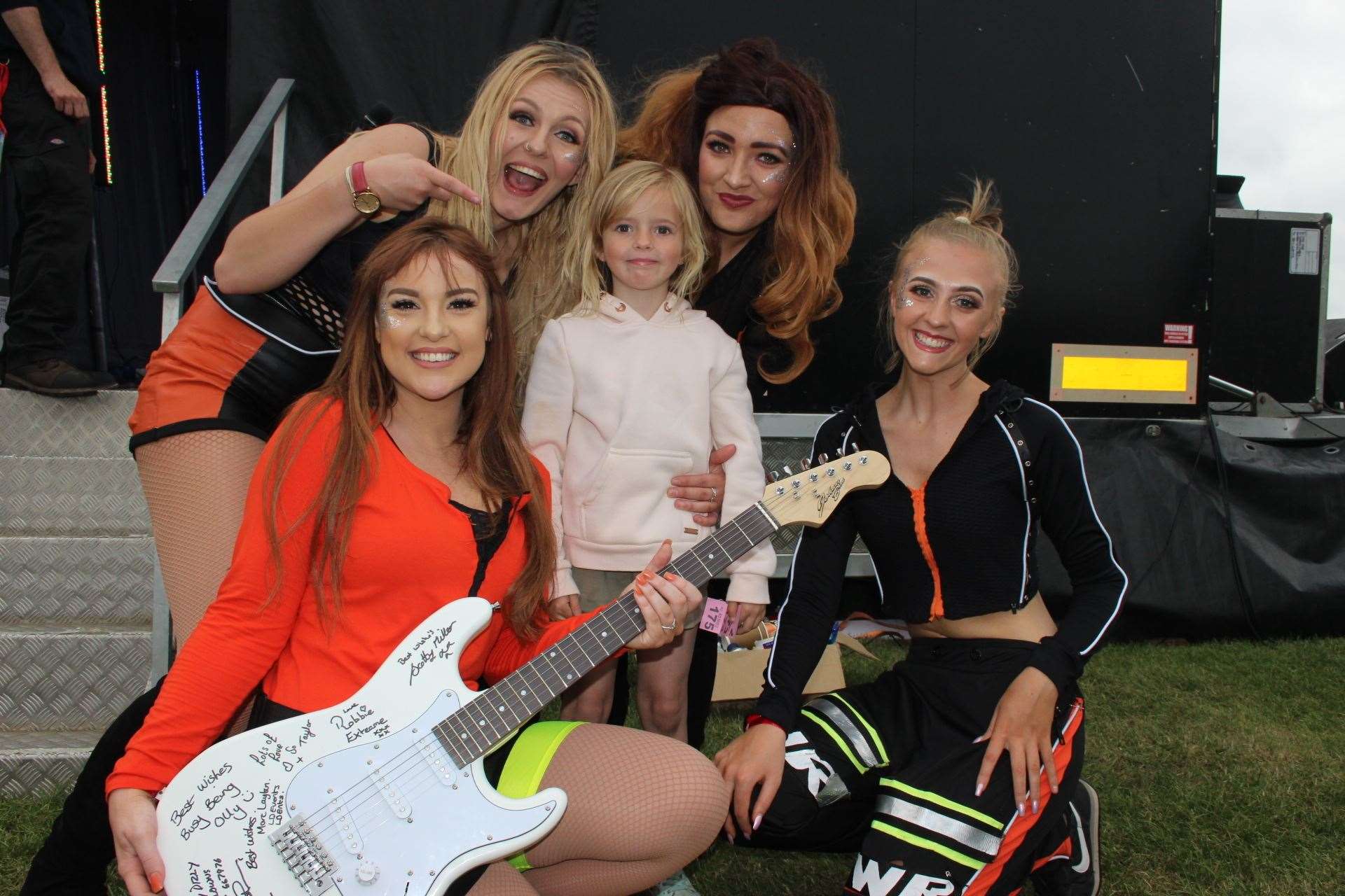 Little Mix group LMX with little Eden Bryant, 6, who won a signed electric guitar at Sheppey's first IsleFest on Sunday. Picture: John Nurden (11228753)