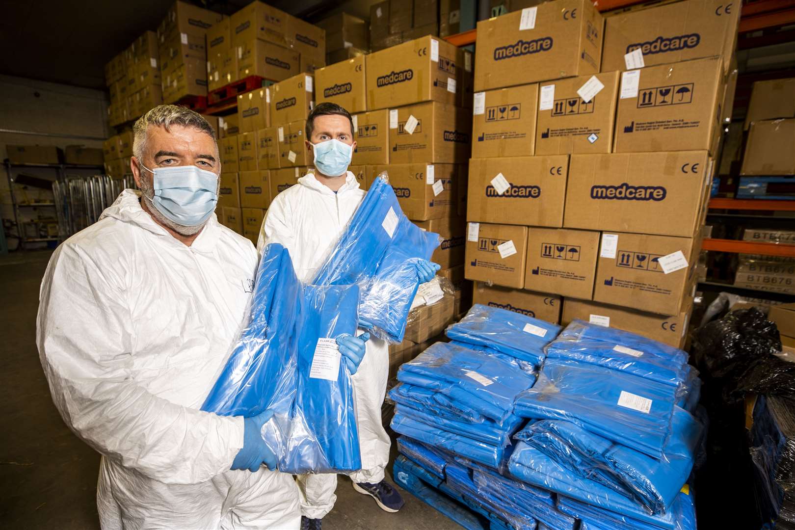 Workers holding PPE at the Belfast Trust in the grounds of Belfast City Hospital (Liam McBurney/PA)