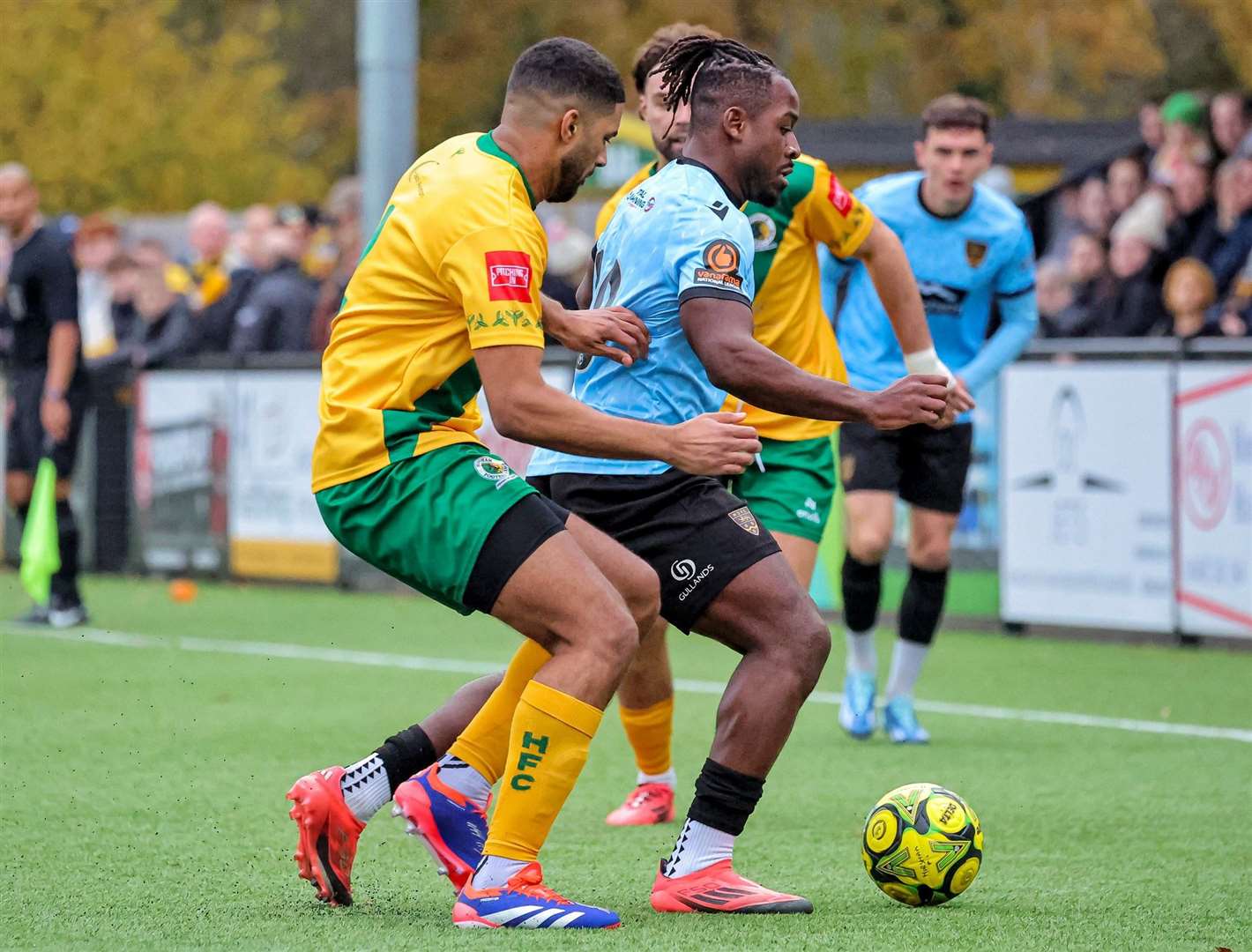 Horsham get two men round Maidstone forward Pierre Fonkeu. Picture: Helen Cooper