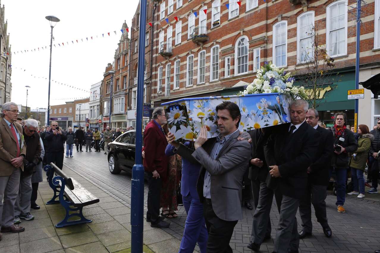 pallbearers proudly carry Kelly's specially designed coffin