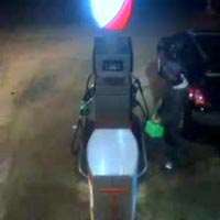 Jerry can being filled up on petrol station forecourt