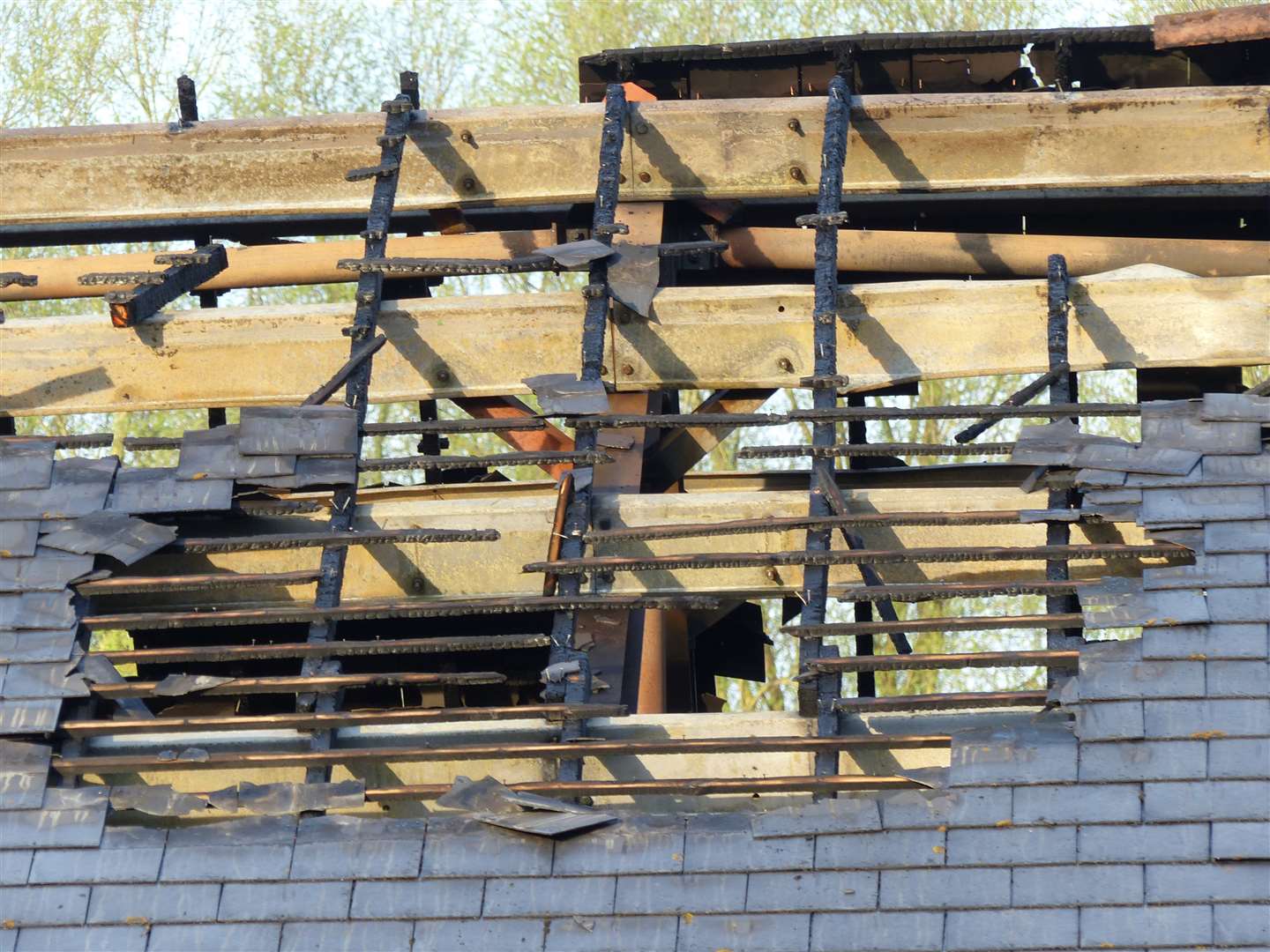 A gaping hole in the fire-damaged roof of the Tesco Express in Ashford Picture: Andy Clark