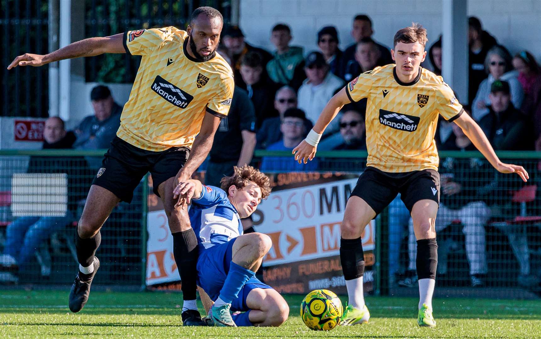 Herne Bay's Artem Kuchkov goes to ground under pressure against Maidstone in Saturday’s FA Cup tie, which they lost 1-0. Picture: Helen Cooper