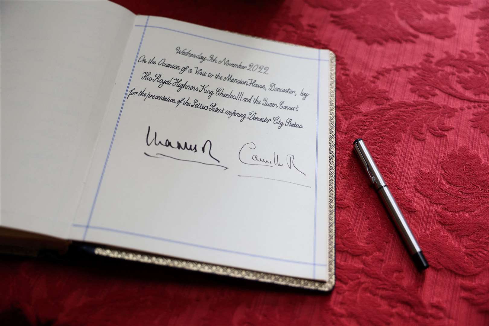 The visitors’ book signed by Charles and Camilla (Molly Darlington/PA)