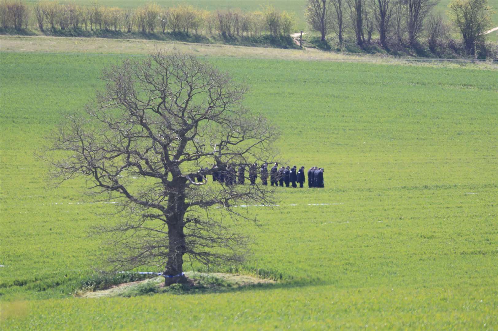 Police officers search a field close to the hamlet of Snowdown, near Aylesham in Kent (Gareth Fuller/PA)