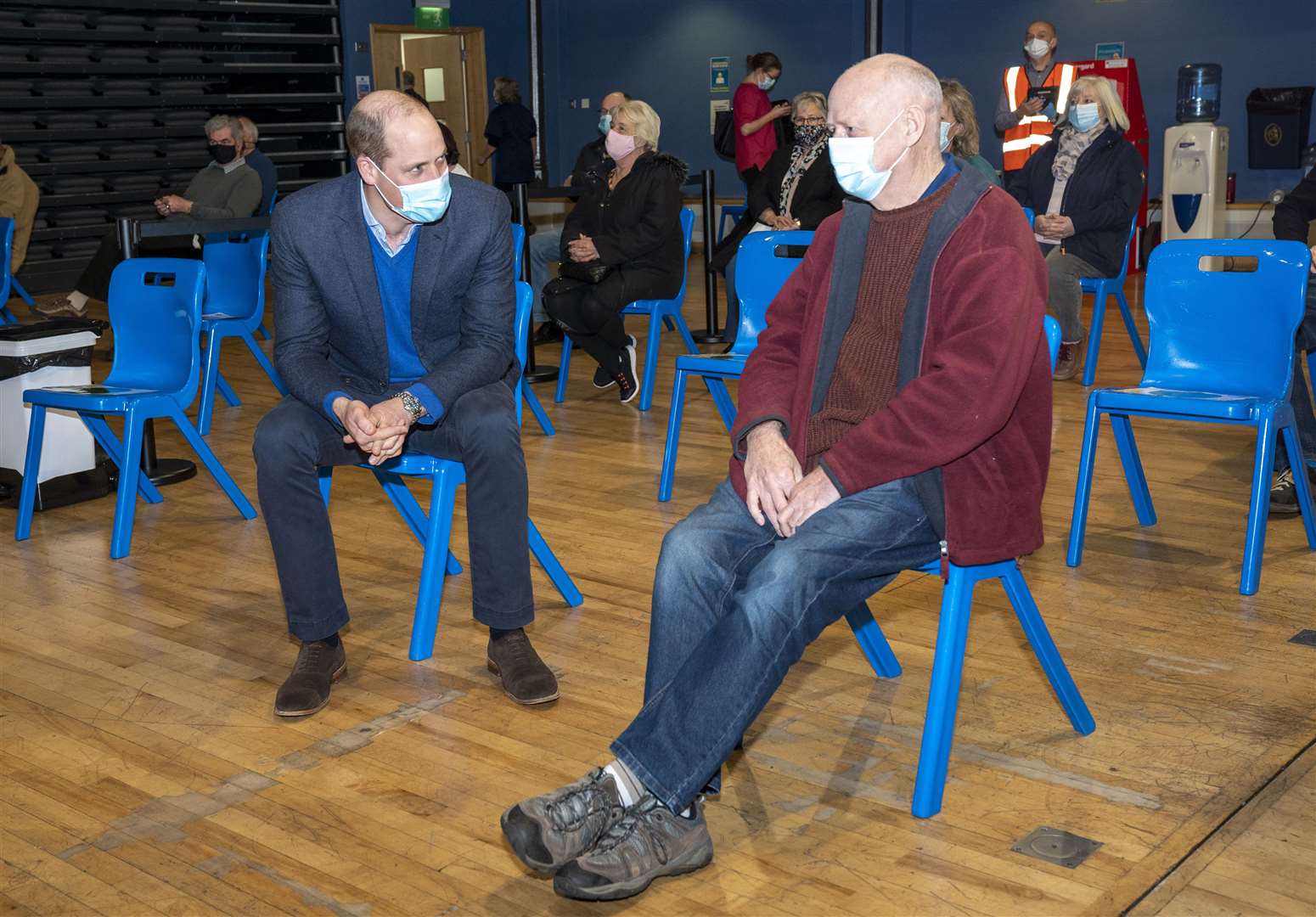 William chats to Geoff Smyth, 66, as he waits to be vaccinated at King’s Lynn Corn Exchange. Arthur Edwards/The Sun