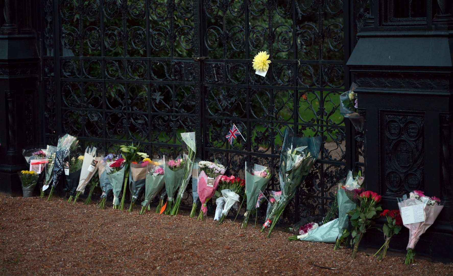 Flowers being laid at Sandringham Gates in memory of the Queen who has died