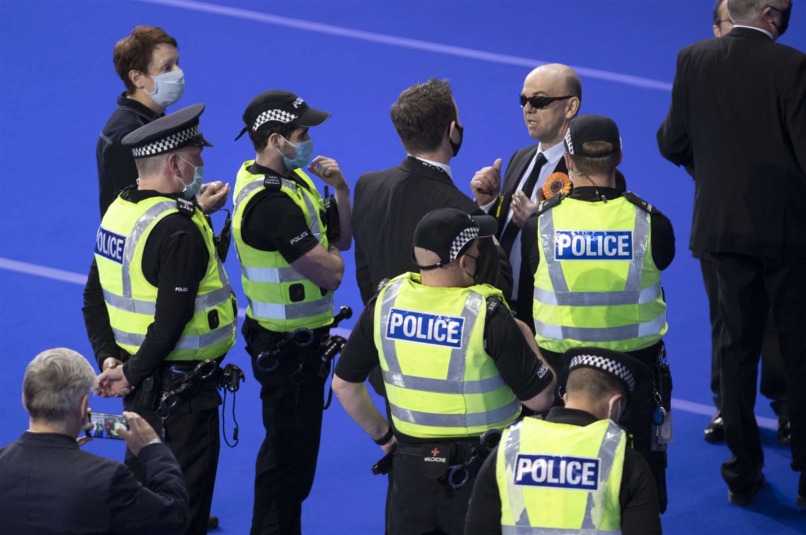 Police speak with members of the Liberal Party before they are removed from the Glasgow count (Jane Barlow/PA)