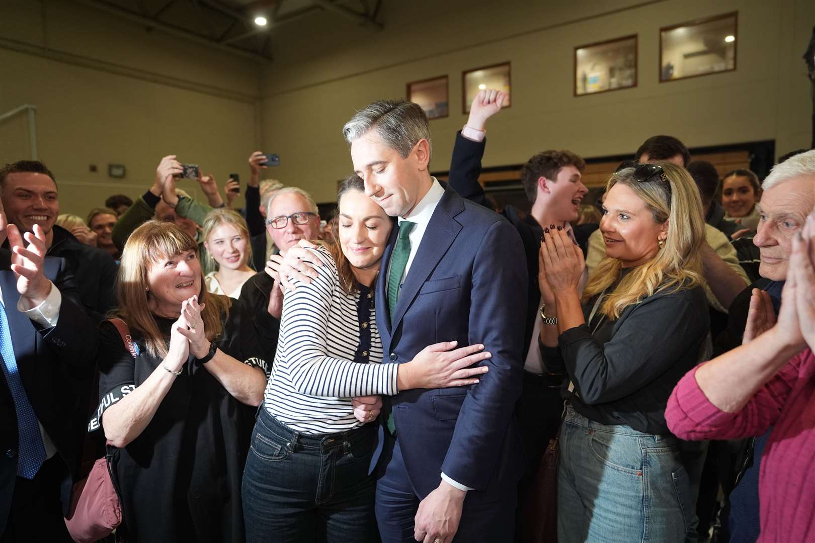 Irish premier Simon Harris is hugged by his wife Caoimhe after being re-elected to the Dail parliament as a TD for Wicklow (Niall Carson/PA)