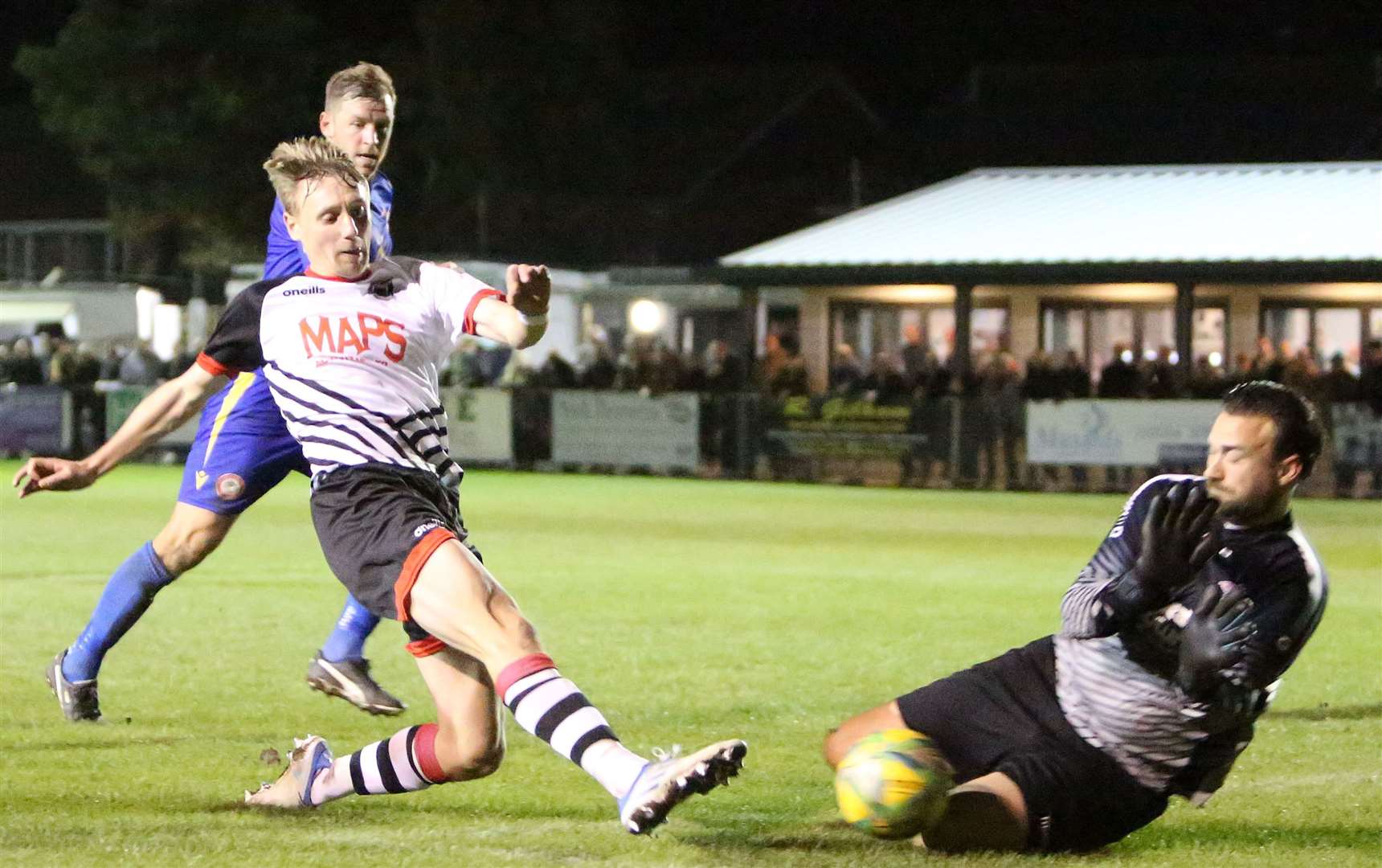 Hollands & Blair goalkeeper Dan Ellis saves at the feet of Deal's Ben Chapman. Picture: Paul Willmott