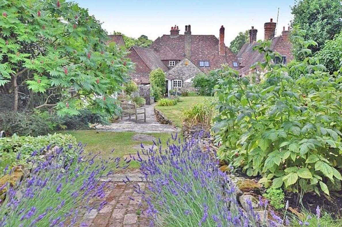 The walled cottage gardens include an extensive paved sun terrace, 'ideal for alfresco dining'. Picture: Zoopla / Ferris & Co