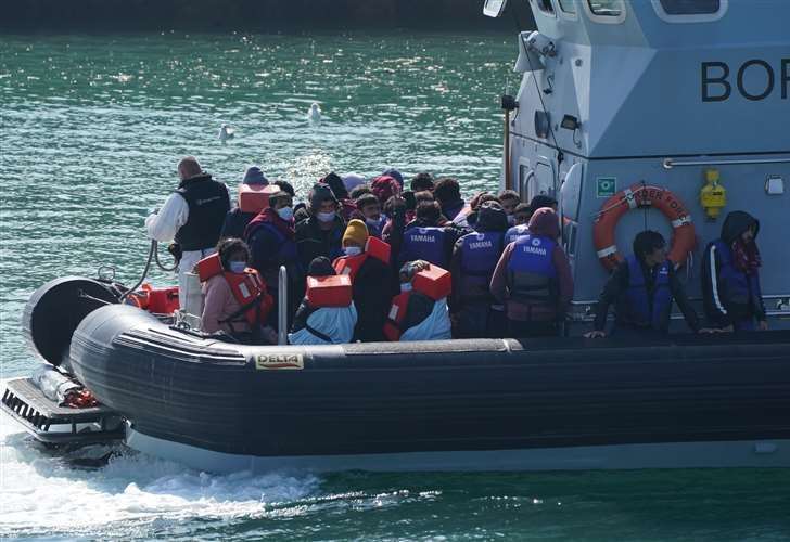 Asylum seekers, including children, arrive in Dover after crossing Channel