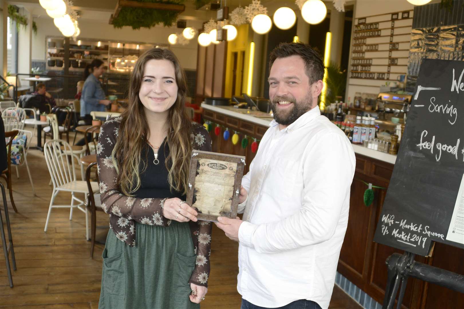 Owner Ben Cuthbert and manager Rheanna Harman with the receipt found during renovation work. Picture: Paul Amos