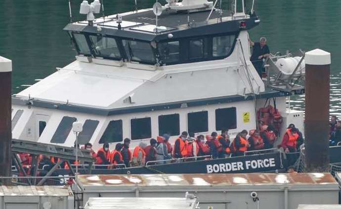 A group of people thought to be asylum seekers are brought in to Dover. Photo: Gareth Fuller/PA