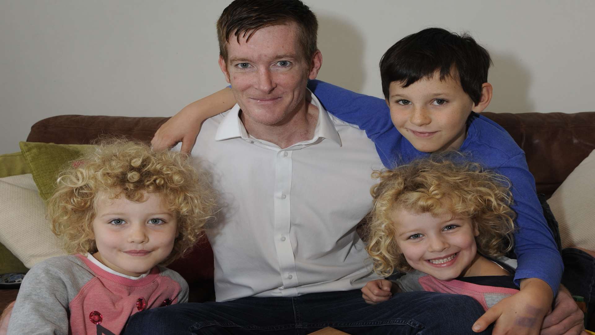 Paul Cartwright with his twin daughters Maya and Ruby, aged six, and partner's son Alex, aged eight