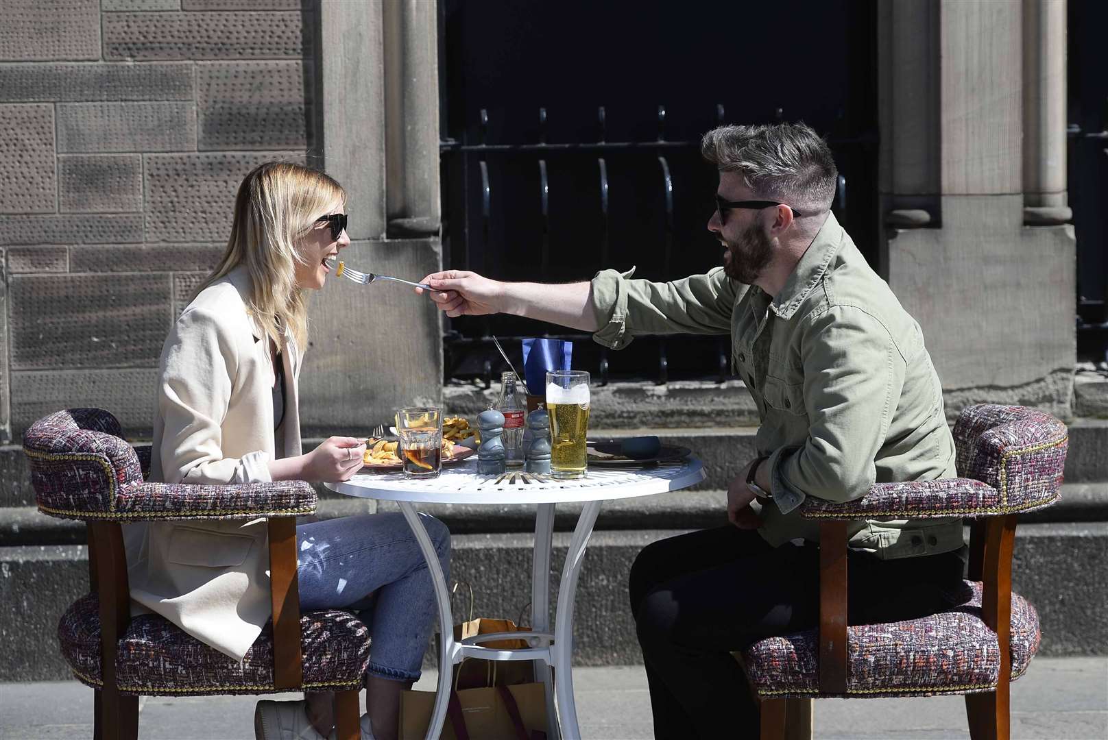 Members of the public enjoy a drink and a meal in Belfast (Mark Marlow/PA)