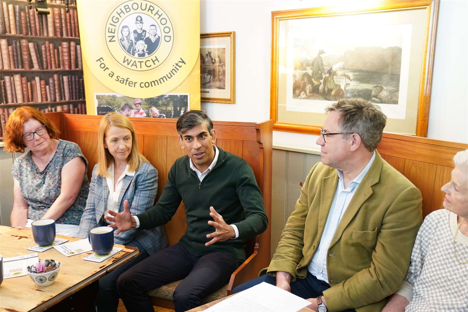 Prime Minister Rishi Sunak attends a Neighbourhood Watch meeting at the Dog and Bacon pub in Horsham, West Sussex, while on the General Election campaign trail (Gareth Fuller/PA)