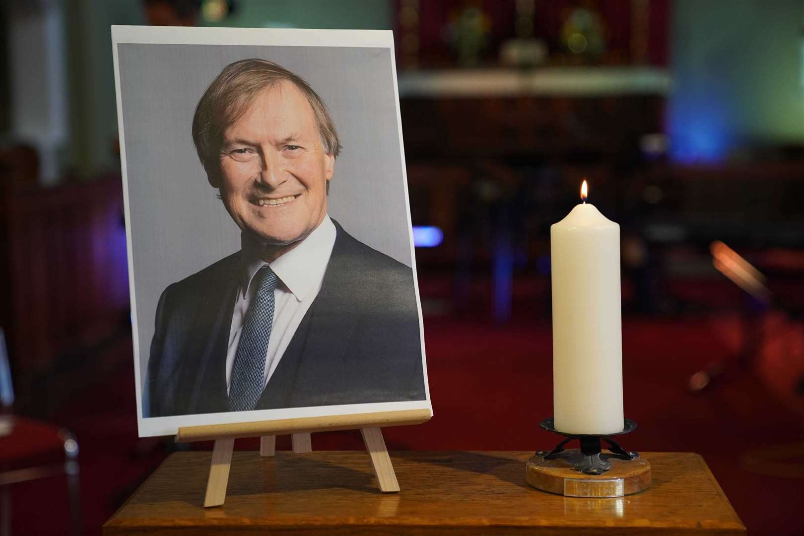 A candle and a photo of Sir David Amess greeted mourners at a vigil in Essex. Picture: Kirsty O’Connor/PA