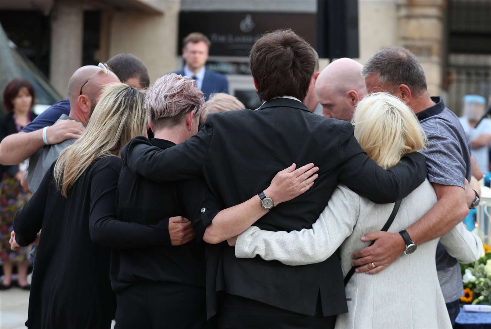 Family members of the three victims comfort each other (Steve Parsons/PA)